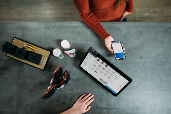 Person using phone to pay at retailer