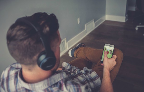 Man on phone wearing headphones