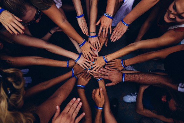 Group of people with hands in circle