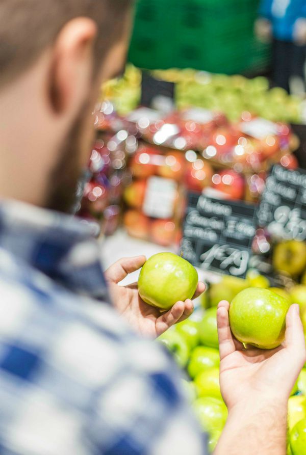 Person buying green apples