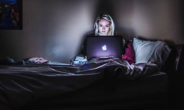 Woman using computer late at night