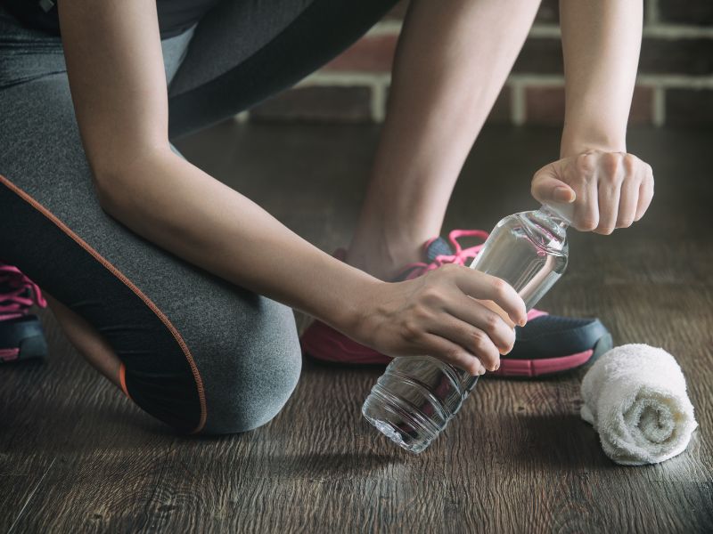 Person saving money at the gym by bringing their own water