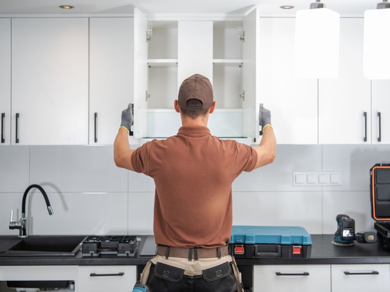 Handman fixing cabinets